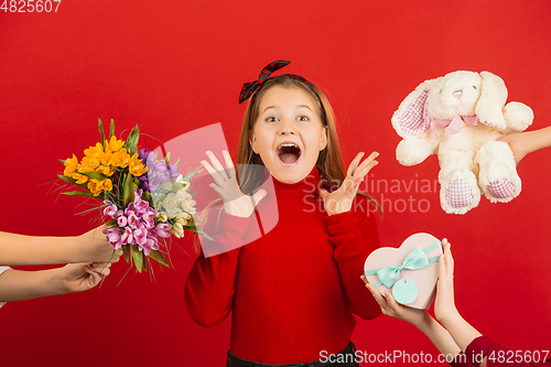 Image of Valentine\'s day celebration, happy caucasian girl isolated on red background