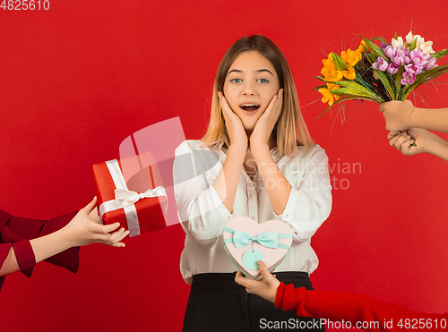 Image of Valentine\'s day celebration, happy caucasian girl isolated on red background