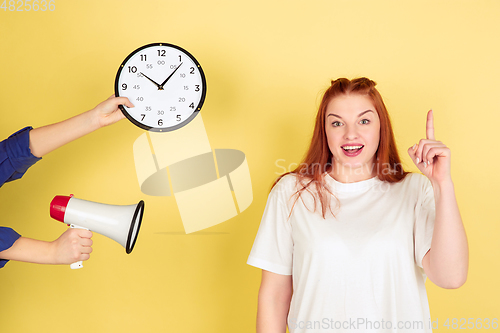 Image of Caucasian young woman\'s portrait on yellow background, too much tasks