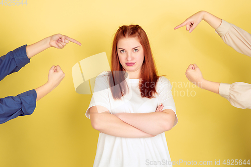 Image of Caucasian young woman\'s portrait on yellow background, too much tasks