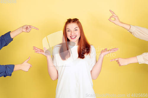 Image of Caucasian young woman\'s portrait on yellow background, too much tasks