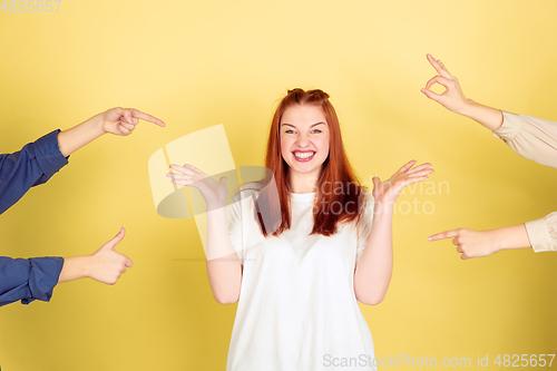 Image of Caucasian young woman\'s portrait on yellow background, too much tasks