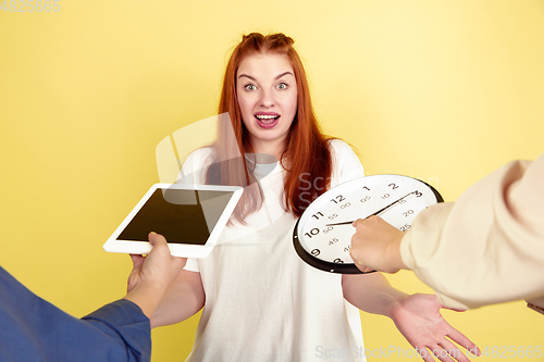 Image of Caucasian young woman\'s portrait on yellow background, too much tasks