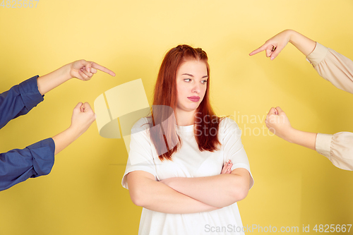 Image of Caucasian young woman\'s portrait on yellow background, too much tasks