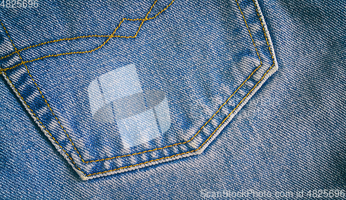 Image of Fragment of classic blue fashioned jeans