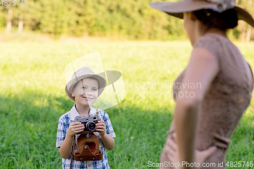 Image of handsome little boy with retro camera and girl model