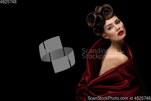 Image of beautiful young woman with fancy hairdo and red lips