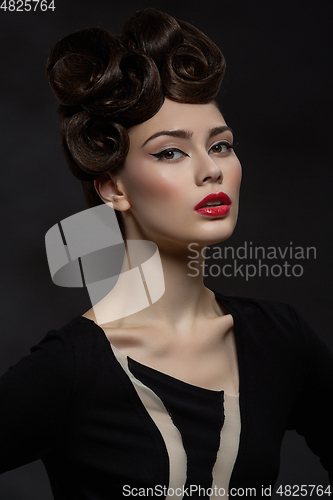 Image of beautiful young woman with fancy hairdo and red lips