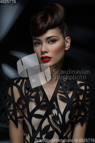 Image of beautiful young woman with fancy hairdo and red lips