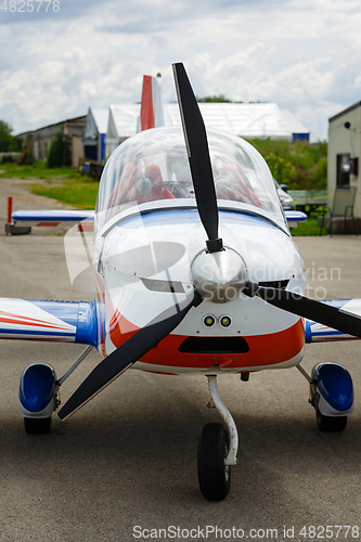 Image of outdoor shot of small plane standing in shed