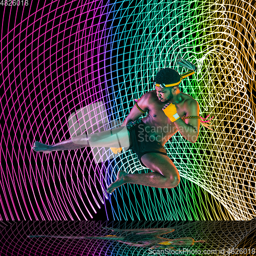 Image of Creative sport and neon waves on dark neon lighted line background