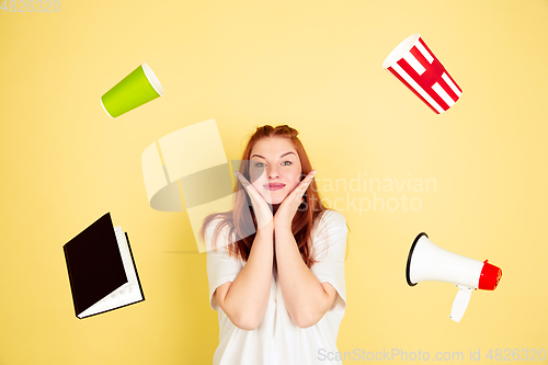 Image of Caucasian young woman\'s portrait on yellow background, too much tasks