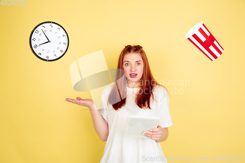 Image of Caucasian young woman\'s portrait on yellow background, too much tasks