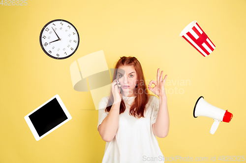 Image of Caucasian young woman\'s portrait on yellow background, too much tasks