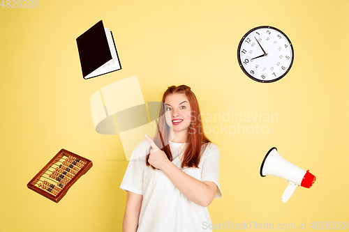 Image of Caucasian young woman\'s portrait on yellow background, too much tasks