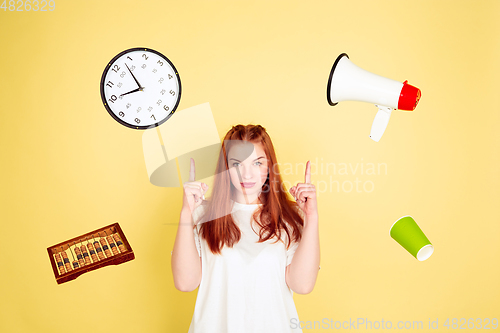 Image of Caucasian young woman\'s portrait on yellow background, too much tasks