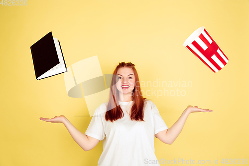 Image of Caucasian young woman\'s portrait on yellow background, too much tasks