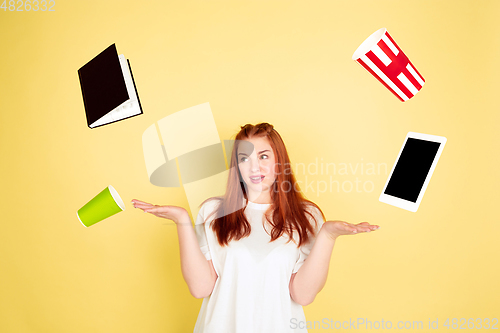 Image of Caucasian young woman\'s portrait on yellow background, too much tasks