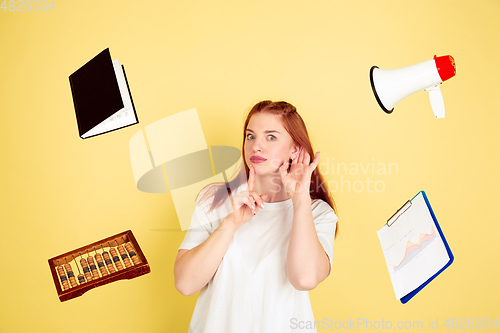 Image of Caucasian young woman\'s portrait on yellow background, too much tasks