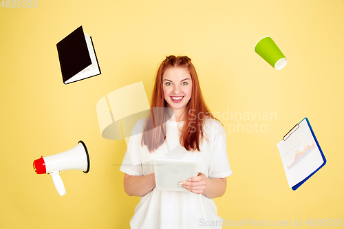 Image of Caucasian young woman\'s portrait on yellow background, too much tasks