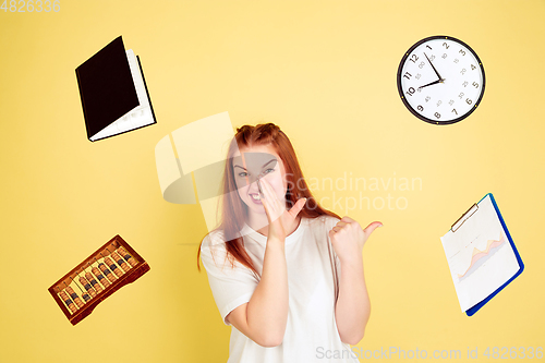 Image of Caucasian young woman\'s portrait on yellow background, too much tasks