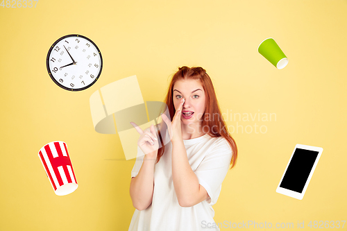 Image of Caucasian young woman\'s portrait on yellow background, too much tasks