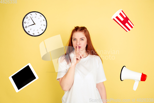 Image of Caucasian young woman\'s portrait on yellow background, too much tasks