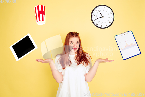 Image of Caucasian young woman\'s portrait on yellow background, too much tasks