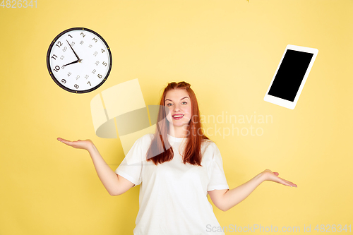 Image of Caucasian young woman\'s portrait on yellow background, too much tasks