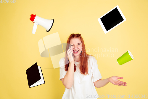 Image of Caucasian young woman\'s portrait on yellow background, too much tasks