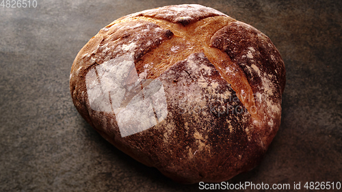 Image of Freshly baked natural bread is on the kitchen table.