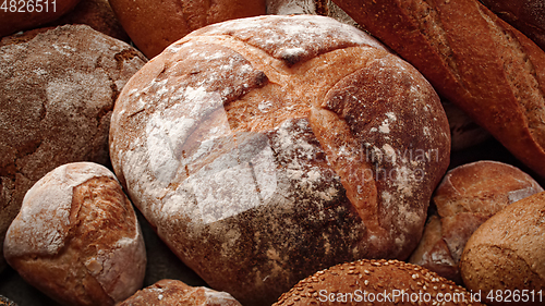 Image of Freshly baked natural bread is on the kitchen table.