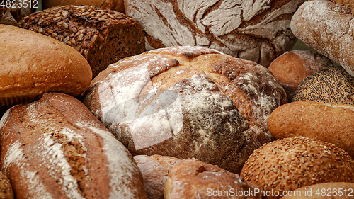 Image of Freshly baked natural bread is on the kitchen table.