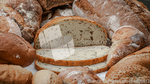 Image of Freshly baked natural bread is on the kitchen table.