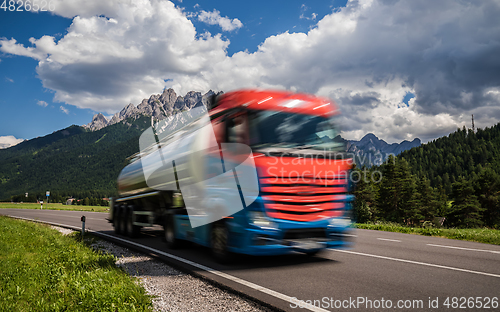 Image of Fuel truck rushes down the highway in the background the Alps. T