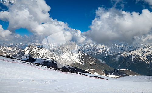 Image of Mountain clouds over beautiful snow-capped peaks of mountains an