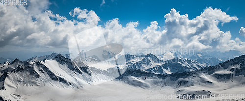 Image of Mountain clouds over beautiful snow-capped peaks of mountains an