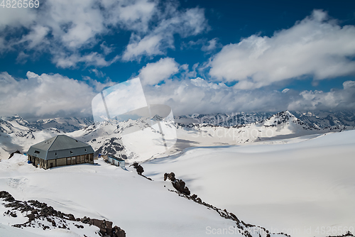 Image of Mountain clouds over beautiful snow-capped peaks of mountains an