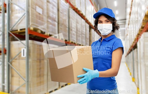 Image of delivery woman in face mask holding parcel box