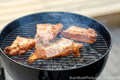 Image of close up of barbecue meat roasting on grill