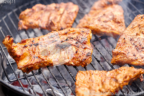 Image of close up of barbecue meat roasting on grill