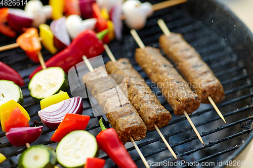 Image of barbecue meat and vegetables roasting on grill