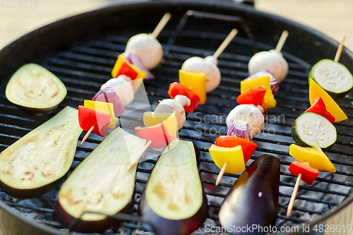 Image of vegetables and mushrooms roasting on brazier grill