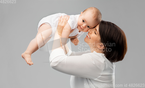 Image of happy middle-aged mother with little baby daughter