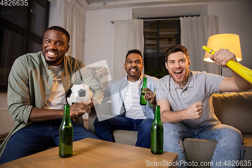 Image of friends or soccer fans with ball and beer at home