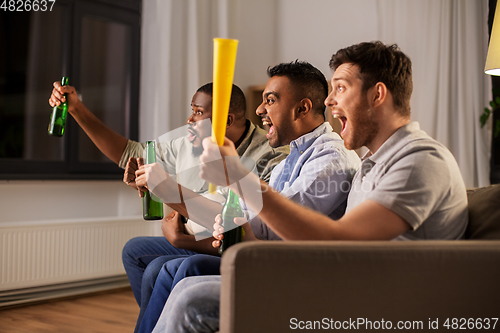 Image of friends or soccer fans with ball and beer at home