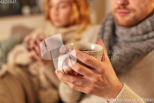 Image of close up of sick young couple drinking tea at home