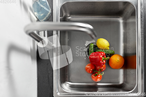 Image of fruits and vegetables in kitchen sink