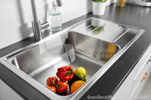 Image of fruits and vegetables in kitchen sink