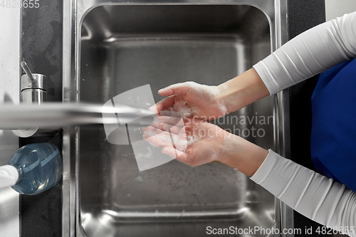 Image of doctor or nurse washing hands with liquid soap